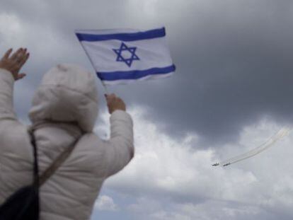 Una mujer sostiene una bandera israel&iacute; durante una demostraci&oacute;n militar, este jueves en Tel Aviv.