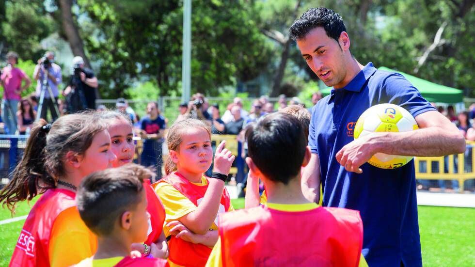 Niños y niñas junto al jugador del FC Barcelona Sergio Busquets.