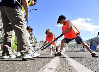 Varios niños juegan al hockey en Madrid en el Día del Deporte.