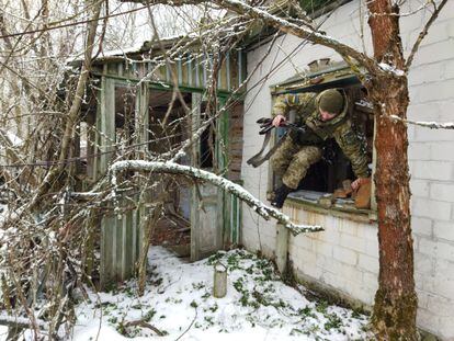 A Ukrainian soldier inspects an abandoned house in a village in the Chernobyl exclusion zone.