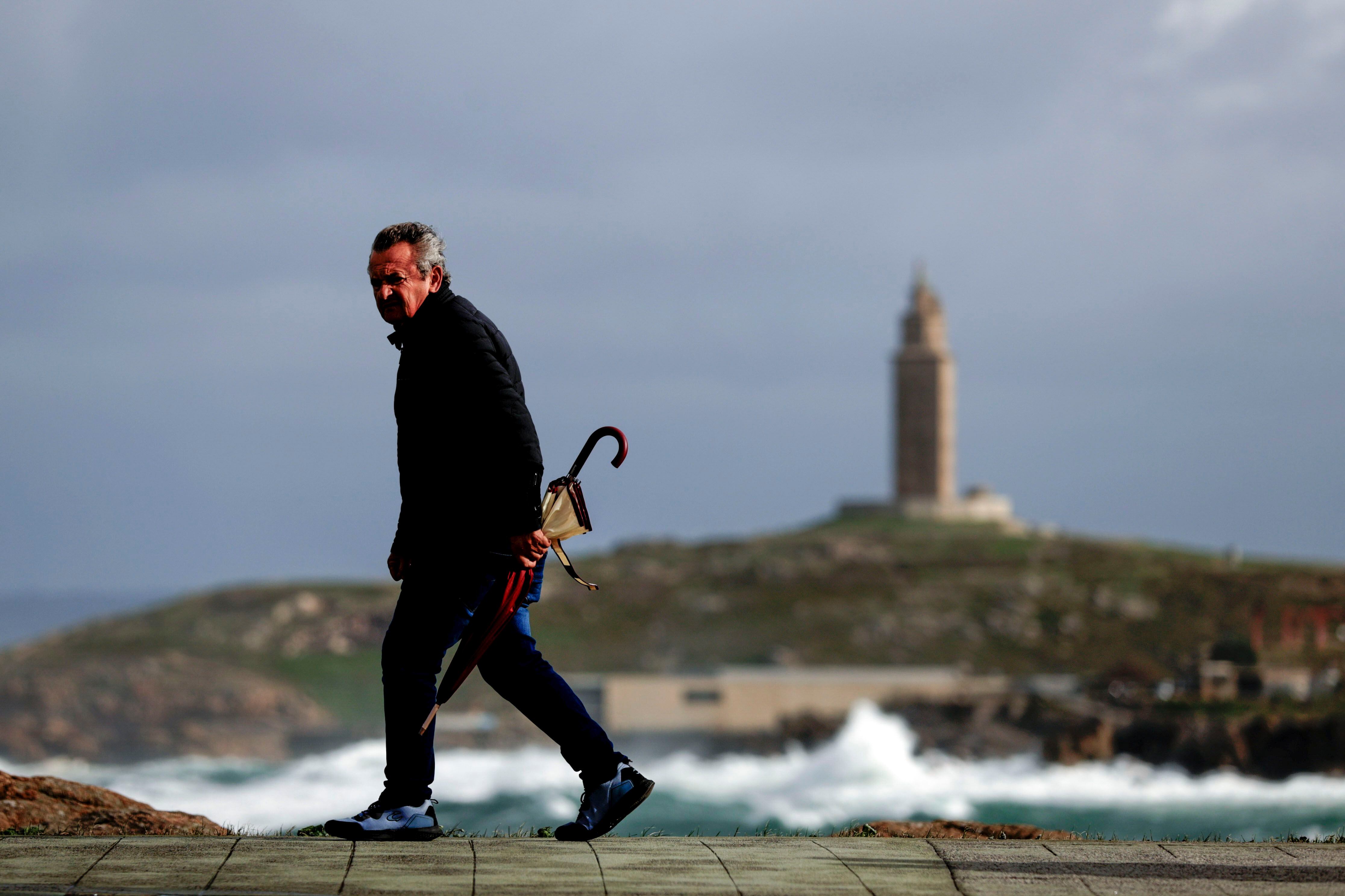 Un hombre caminaba este jueves por el paseo marítimo de A Coruña. 