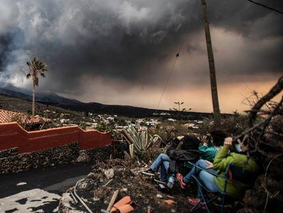 Varios turistas contemplan la erupción volcánica en la isla de La Palma