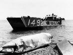 A U.S. landing craft back off shore after dropping battered wingtank recovered from the Mediterranean where a search for a missing nuclear device has been on since the B 52 crash in Palomares, Spain on Jan. 17, 1966. (AP Photo)