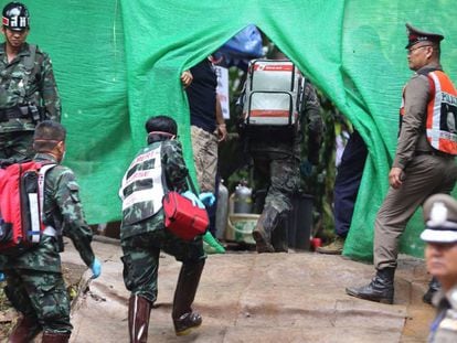 Personal médico accede a una zona restringida durante los preparativos para transportar a los niños rescatados al hospital en los alrededores de la cueva Tham Luang, este domingo, en Tailandia.