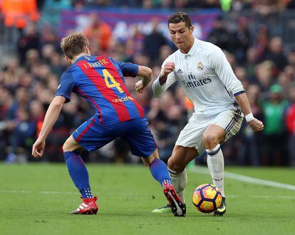 El davanter portuguès del Reial Madrid Cristiano Ronaldo (dreta) lluita per la pilota amb el migcampista croat Ivan Rakitic.