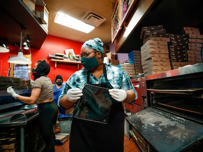 Empleadas de la pizzeria Dimo's fabrican mascarillas de acrílico en Chicago.
