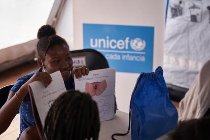 Weedaina Jagued shows what she has drawn and learned during the menstrual hygiene workshop, a UNICEF initiative provided by her partner HIAS to migrant adolescents.