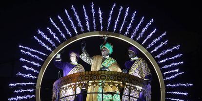 Baltasar saluda desde su carroza junto a dos pajes reales durante la cabalgata de Reyes Magos de 2021 en Madrid.