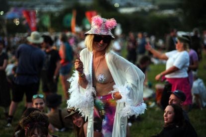 A Glastonbury festival-goer in Somerset, south-west England, on Wednesday.  More than 200,000 music fans and stars including Paul McCartney, Billie Eilish and Kendrick Lamar have descended on the English countryside for the festival this week, after a three-year hiatus due to the pandemic. 