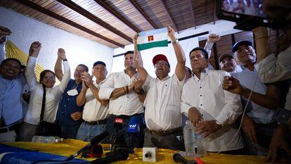 El candidato opositor a la Gobernación de Barinas, Sergio Garrido, muestra la bandera del estado durante una rueda de prensa. Garrido se reconoció este domingo como ganador de la repetición de los comicios.