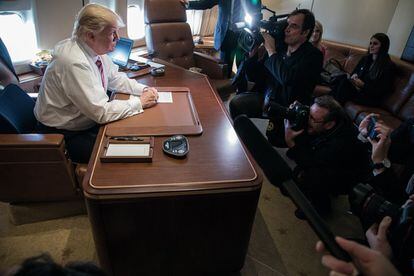 El presidente Donald Trump habla con miembros de la prensa en su oficina a bordo del Air Force One durante un vuelo desde Filadelfia, Pennsylvania, a Joint Base Andrews en Maryland, el 26 de enero de 2017.