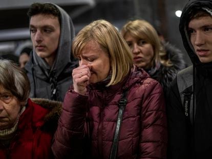 A displaced Ukrainian woman cries as she waits to get on a train to Poland, at the Lviv railway station, in Lviv, western Ukraine, Thursday, March 3, 2022. Russia’s invasion of Ukraine has forced more than a million people to flee their homeland in just a week. (AP Photo/Bernat Armangue)
