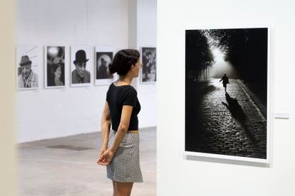 A visitor to the exhibition 'Observing Life', dedicated to Sabine Weiss.