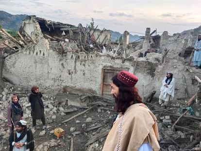 In this photo released by a set-run news agency Bakhtar, Afghans look at destruction caused by an earthquake in the province of Paktika, eastern Afghanistan, Wednesday, June 22, 2022. (Bakhtar News Agency via AP)