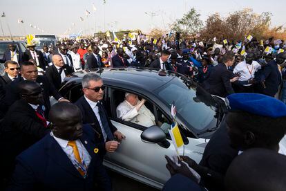 Pope Francis leaves in his vehicle among crowds gathered at the entrance of the airport in Juba, South Sudan, on Friday.