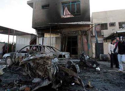 Civiles iraquíes, en el lugar de la explosión de uno de los tres coches bomba que han estallado hoy en Bagdad.
