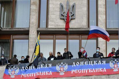 Activistas prorrusos enarbolan banderas rusas en el edificio del Gobierno regional en Donetsk.