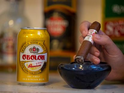 Una persona consume cerveza ucraniana Obolon mientras fuma en un bar de La Habana, Cuba, en febrero.