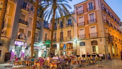 Varias personas cenan en una terraza, en Alicante.