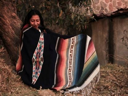 A woman wearing a traditional indigenous Mexican serape.