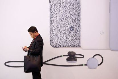 Un hombre mira su teléfono en el stand de Google en el Mobile World Congress (MWC), el 26 de febrero de 2018 en Barcelona.