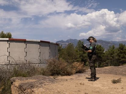 Una agente rural inspecciona un deposito de prevención de incendios en el Berguedà.