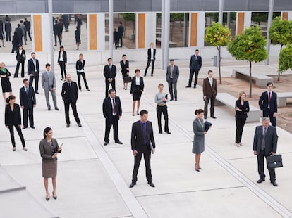 Businesspeople in modern office courtyard