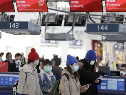 Pasajeros con máscaras en el aeropuerto de Praga, que ha comenzado una campaña de información para viajeros con posibles síntomas de coronavirus, este lunes.