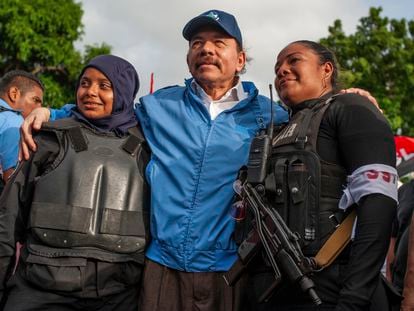 Nicaraguan police have their picture taken with President Daniel Ortega, in Masaya, Nicaragua, Friday, July 13, 2018