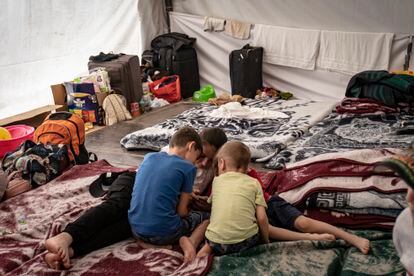 Una familia de ucranianos descansa en colchonetas instaladas en el campamento de Ciudad de México.