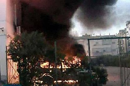 Un coche arde cerca del consulado italiano en Bengasi, al norte de Libia, ayer.
