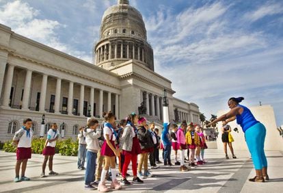 Unos pioneros (estudiantes de nivel de primaria) hacen educación física frente al Capitolio.