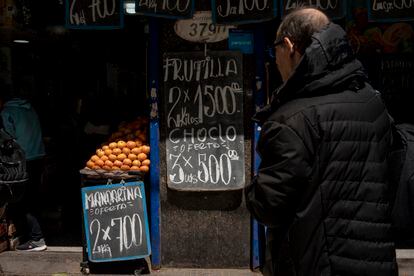 A man looks at the prices in a greengrocer, on October 12.