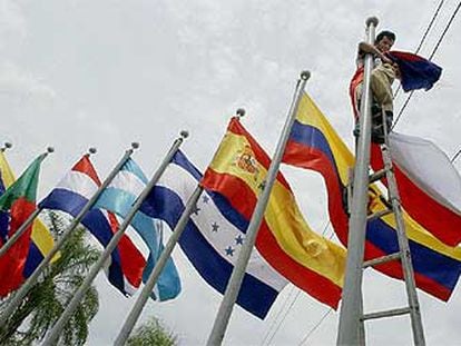 Un trabajador coloca la bandera de uno de los países participantes en la XIII Cumbre Iberoamericana.