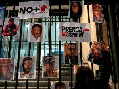 Una mujer coloca una foto de un periodista asesinado durante una manifestación contra la violencia hacia la prensa, el 25 de enero en Ciudad de México.