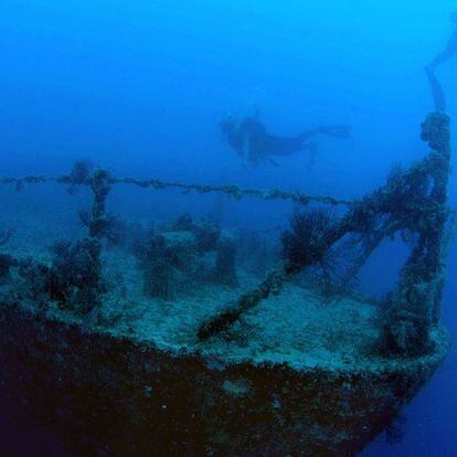 Divers swim on the shipwreck  Spiegel Grove Tuesday, July 12, 2005, of Key Largo, Fla., in the Florida Keys National Marine Sanctuary. Since it was fully sunk on June 10, 2002, the decommissioned Navy Landing Ship Dock has rested on its starboard side. But Monday, July 11, 2005, divers discovered the ship had rolled upright, apparently courtesy of waves spawned by Hurricane Dennis off the southeast coast of Cuba, according to a National Weather Service official. The ship is the largest in the world ever scuttled to become an artificial reef. NO SALES (Photo by Fraser Nivens/Florida Keys News Bureau/HO)