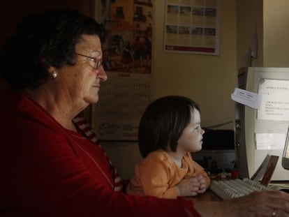 Una àvia amb la seva neta, davant l'ordinador.