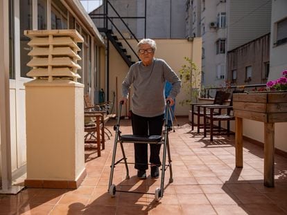 Trinidad López, de 103 años y operada de una fractura de fémur en enero, camina con su andador por la terraza de la residencia en la que vive en Barcelona.