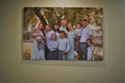 Ihor with his wife, Dana, and their nine children in a photo that hangs in the living room of their house.