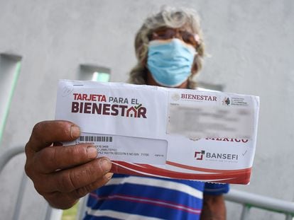 Una persona de la tercera edad muestra su tarjeta del programa Pensión para el Bienestar en Campeche.
