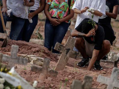 Un hombre llora en un funeral en Río de Janeiro, Brasil, tras la muerte de una mujer por covid-19.
