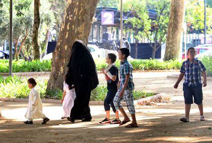 Una mujer pasea con sus hijos por Lleida tras asistir al fin del Ramadán. 