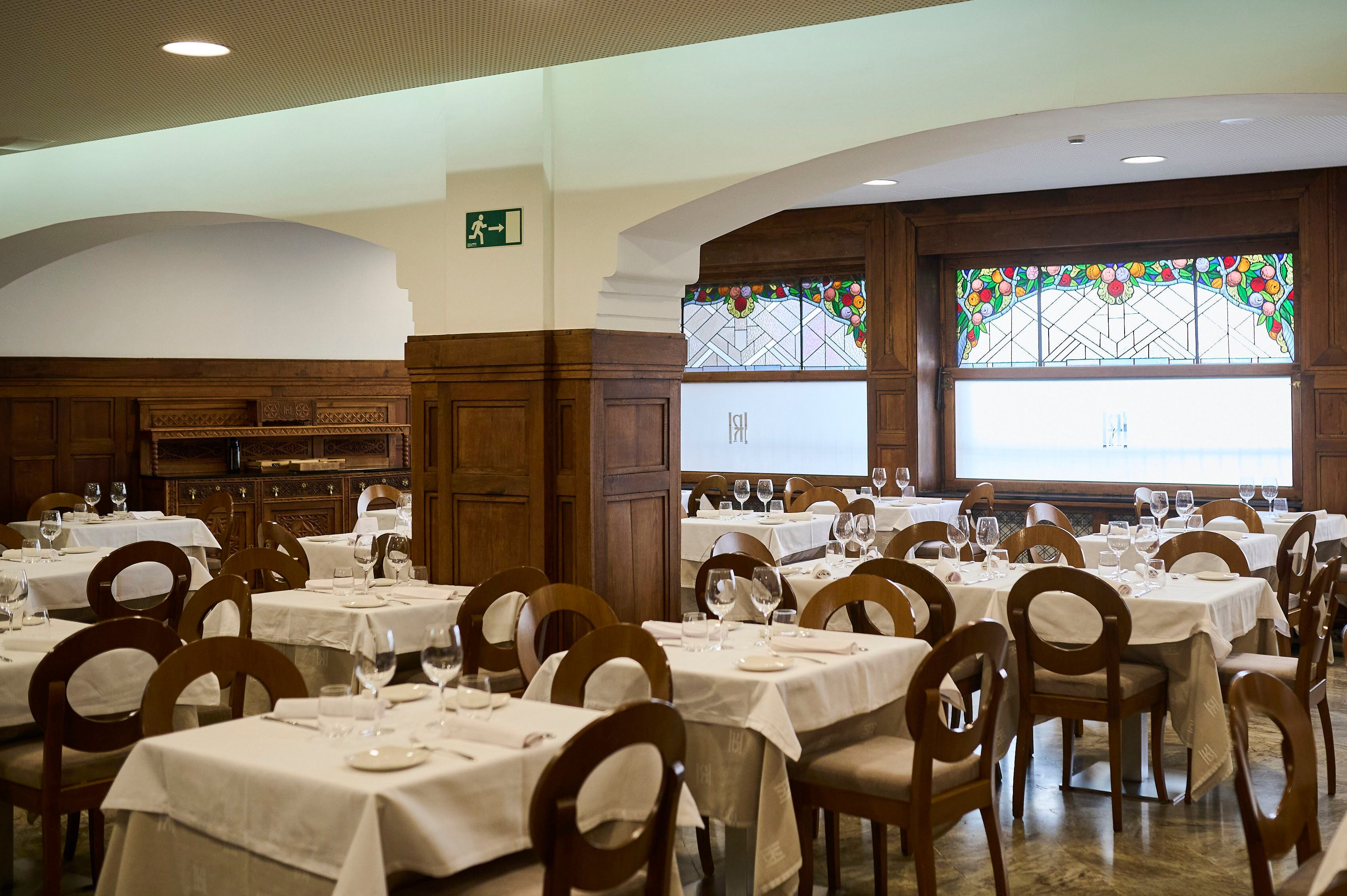Las molduras de madera traídas de San Sebastián en 1936 y las vidrieras son las señas de identidad de la sala principal del restaurante.
