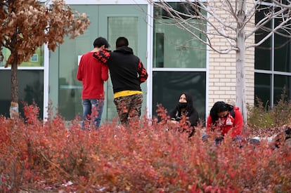 Students wait to enter their school.