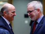 Spain's outgoing Economy Minister de Guindos listens to EIB President Hoyer during a EU finance ministers meeting in Brussels