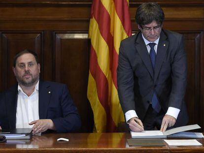 Carles Puigdemont y Oriol Junqueras este mi&eacute;rcoles durante la firma de la ley del refer&eacute;ndum del 1 de octubre en Catalu&ntilde;a.
