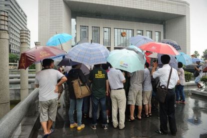Un grupo de periodistas espera fuera de la corte donde se efectuó el juicio contra Gu Kailai.