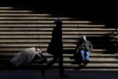 Un mendigo duerme en Wall Street, Nueva York.