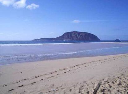 La isla Montaña Clara, al fondo, vista desde la playa de las Conchas en la isla La Graciosa.