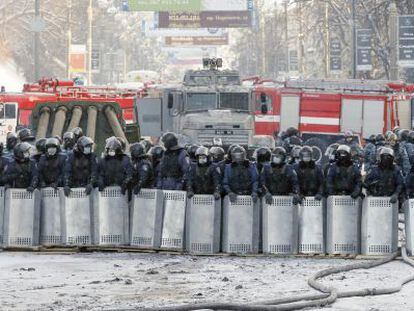 Polic&iacute;as antidisturbios montan guardia durante una tregua en las protestas en Kiev.